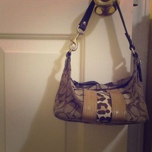This is a Light and dark brown Coach purse.